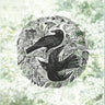 A circular black-and-white linocut or woodcut-style decal by Angela Harding featuring two blackbirds among a mulberry tree